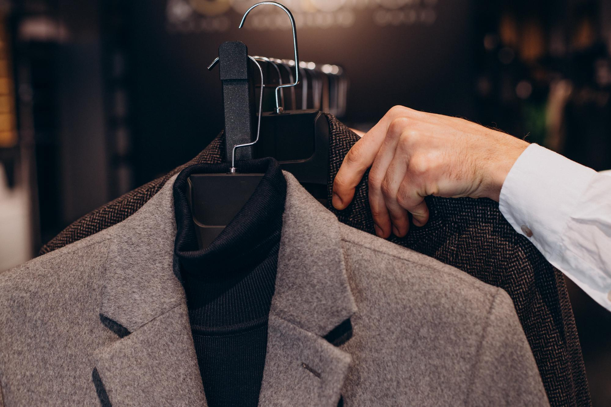 young-man-choosing-cloths-menswear-shop young-man-choosing-cloths-menswear-shop