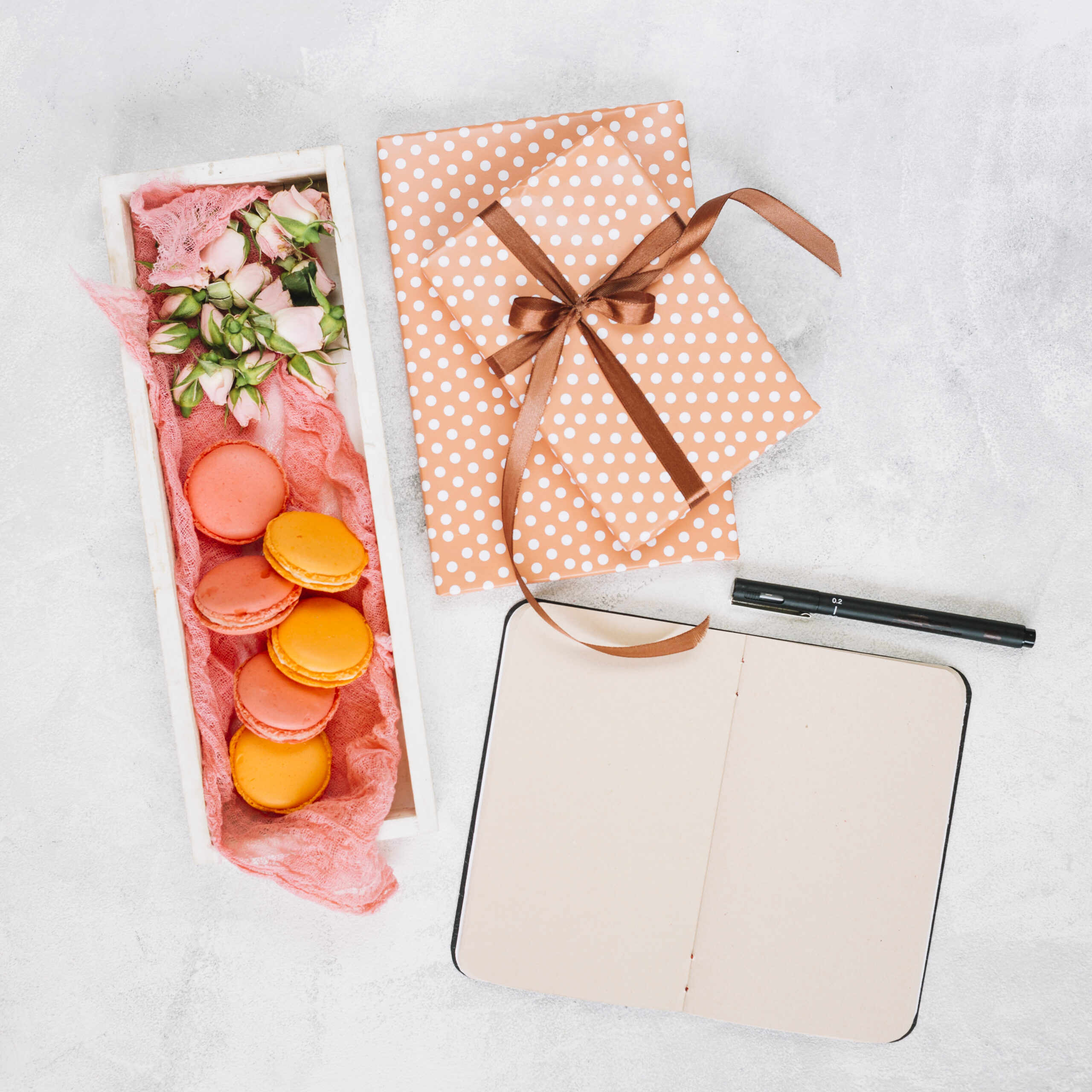 notebook-pen-near-dessert-presents