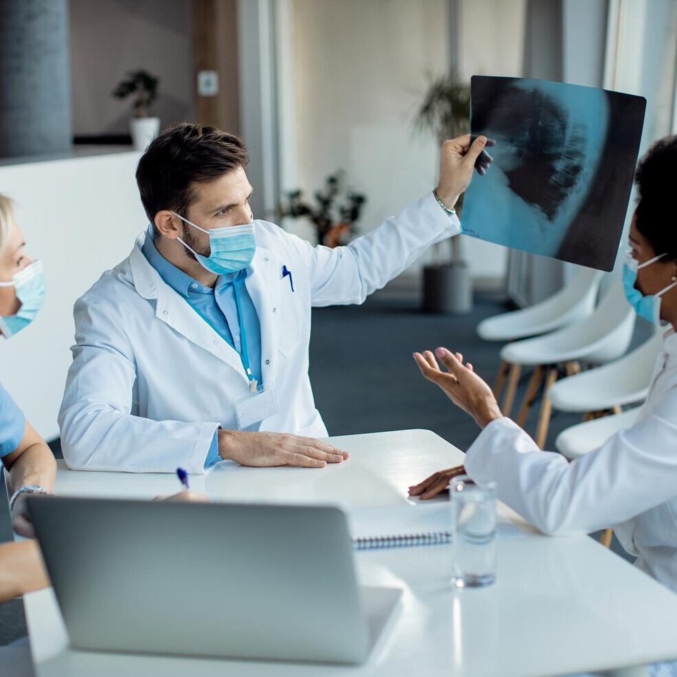 team-healthcare-experts-examining-xray-image-medical-clinic_637285-11162